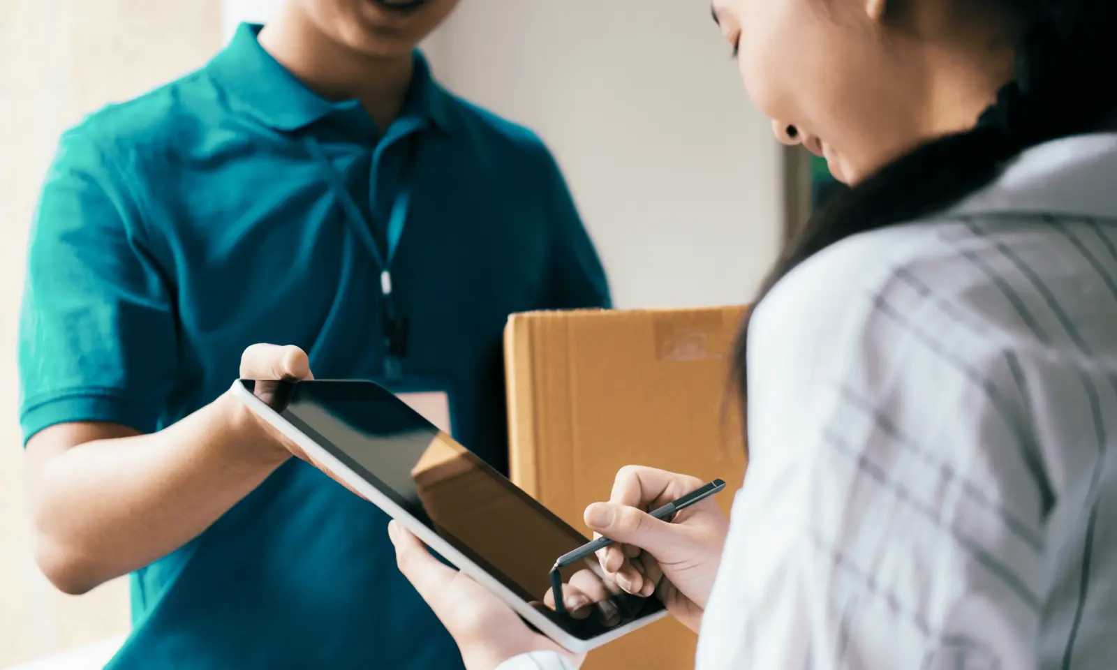 Customer signing for a delivery on a driver’s tablet