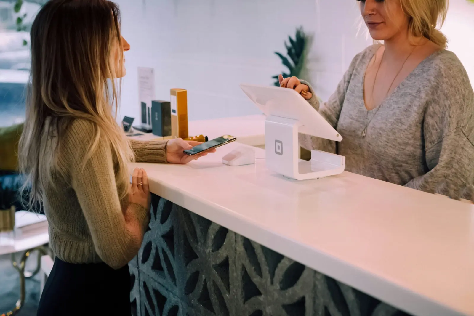 Customer paying at a retail shop counter with an EPOS terminal